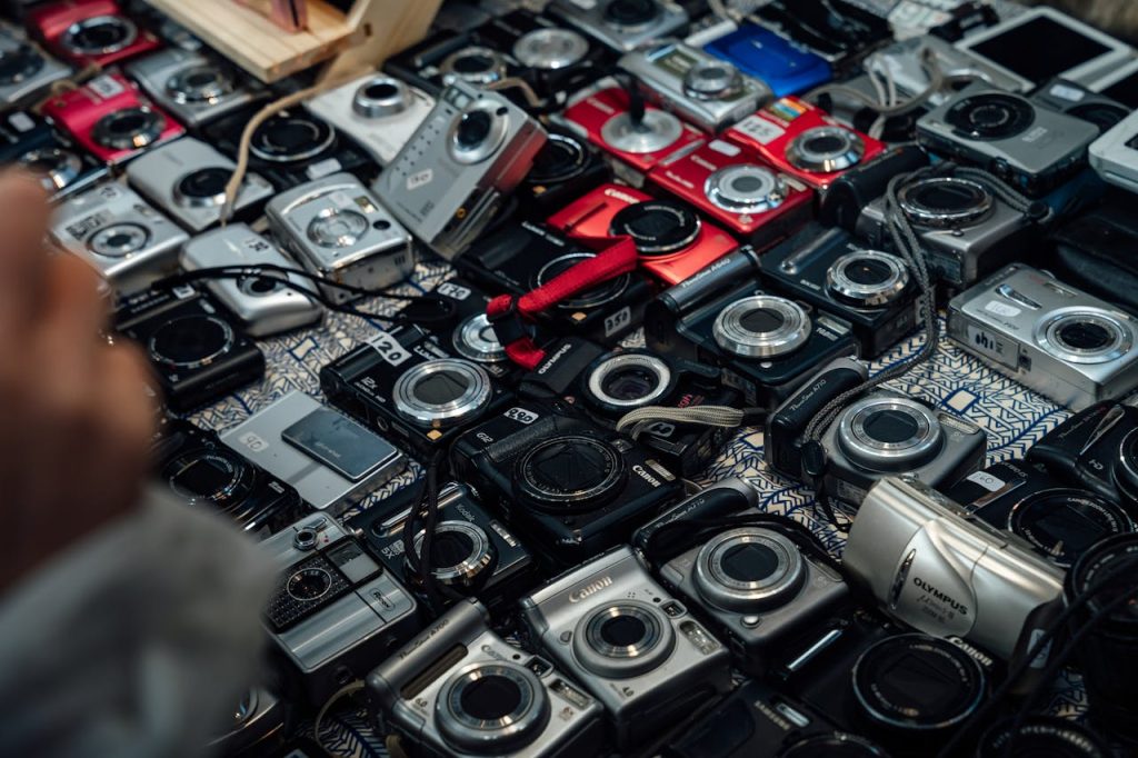 Assorted vintage cameras arranged on a patterned table in London, England.